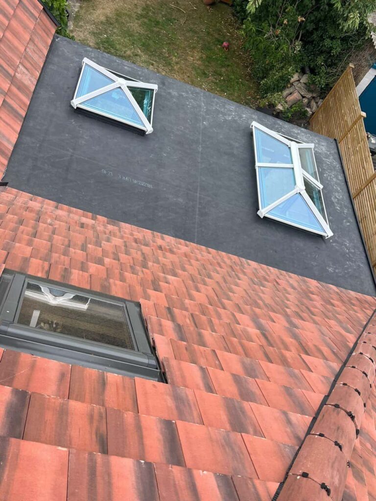 This is a photo taken from the roof ridge looking down a tiled pitched roof on to a flat roof. Works carried out by TRP Roofing Molescroft